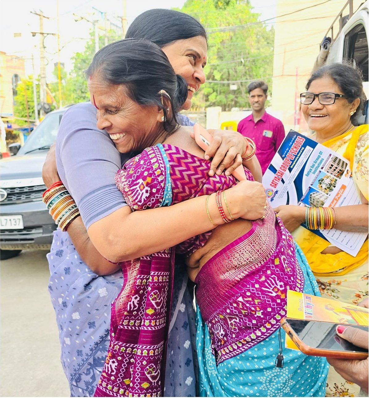 Two women embracing and laughing outside the skill centre