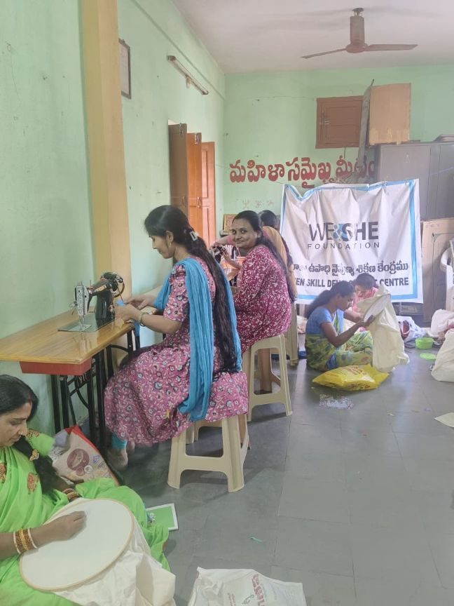 Trainees measuring and marking fabric on the floor of the training room